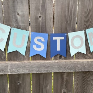 May include: A blue and light blue banner with the word "CUSTOM" spelled out in white letters.
