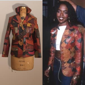 May include: A patchwork leather jacket in shades of red, brown, and black. The jacket has a collared neckline, button closure, and multiple pockets. The jacket is displayed on a mannequin. The jacket is also shown being worn by a person.