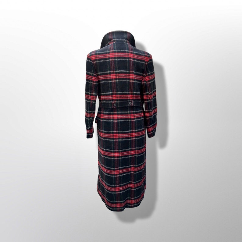 May include: A long, black and red plaid coat with a wide collar and a belted waist. The coat has long sleeves and a button closure. The plaid pattern is a classic design, suitable for fall and winter wear.