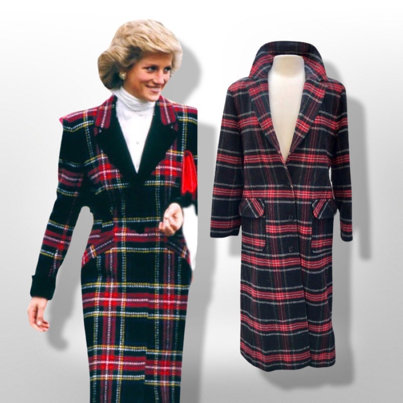 May include: A black, red, and yellow plaid coat with a double-breasted design. The coat has a wide collar and two front pockets. The coat is displayed on a mannequin. The coat is a vintage style.