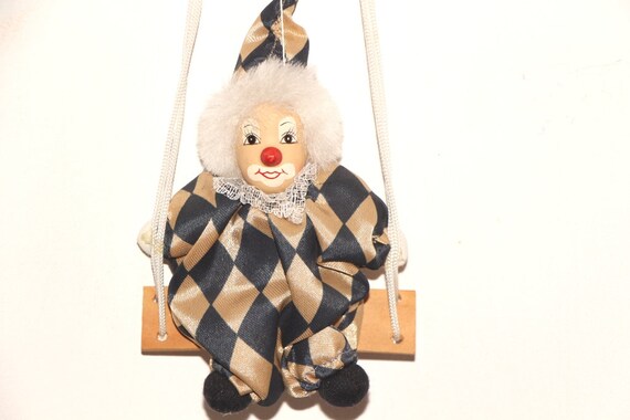 porcelain clown doll on swing
