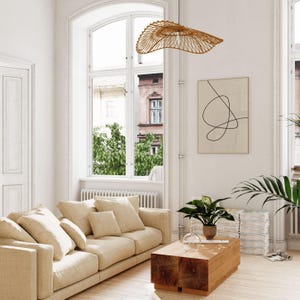 A bright and airy living room showing a printable wall art in situ