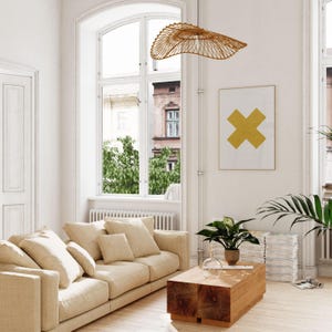A bright and airy living room showing a printable wall art in situ