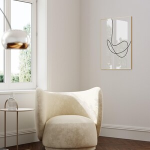 A bright and airy living room showing a printable wall art in situ