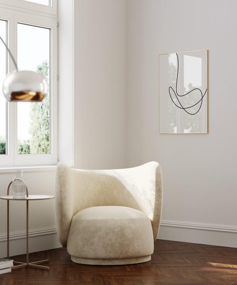 A bright and airy living room showing a printable wall art in situ