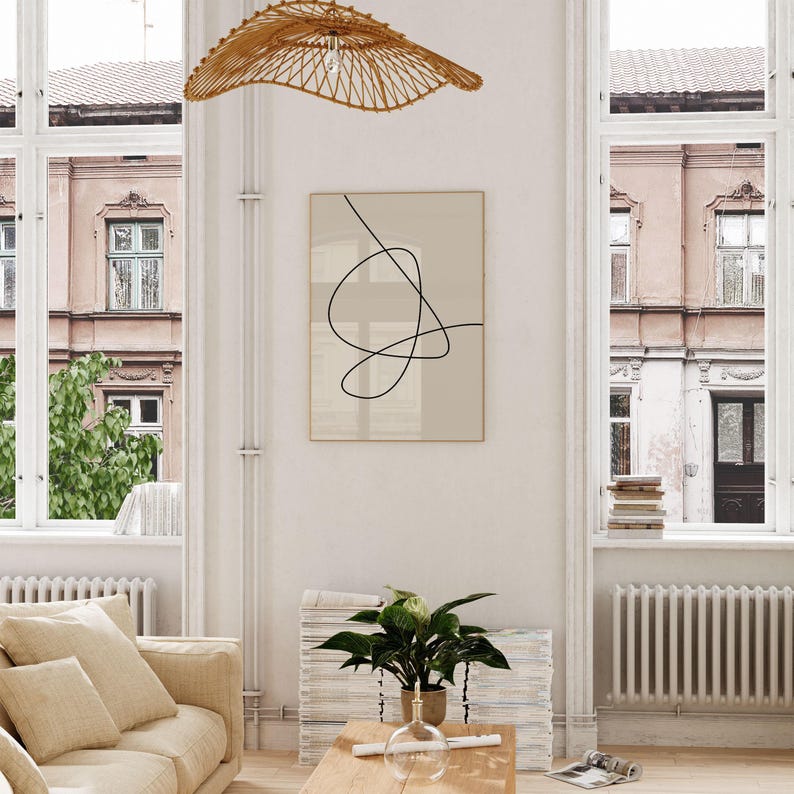 A bright and airy living room showing a printable wall art in situ