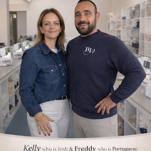 May include: Two business owners standing in a workshop. The text reads: MEET YOUR SMALL BUSINESS OWNERS. Kelly who is Irish & Freddy who is Portuguese. Our small business is based in Portugal and handmade and ships all your orders from here.