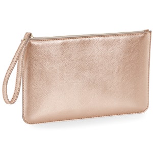 May include: A rose gold clutch purse with a zipper closure and a wrist strap.