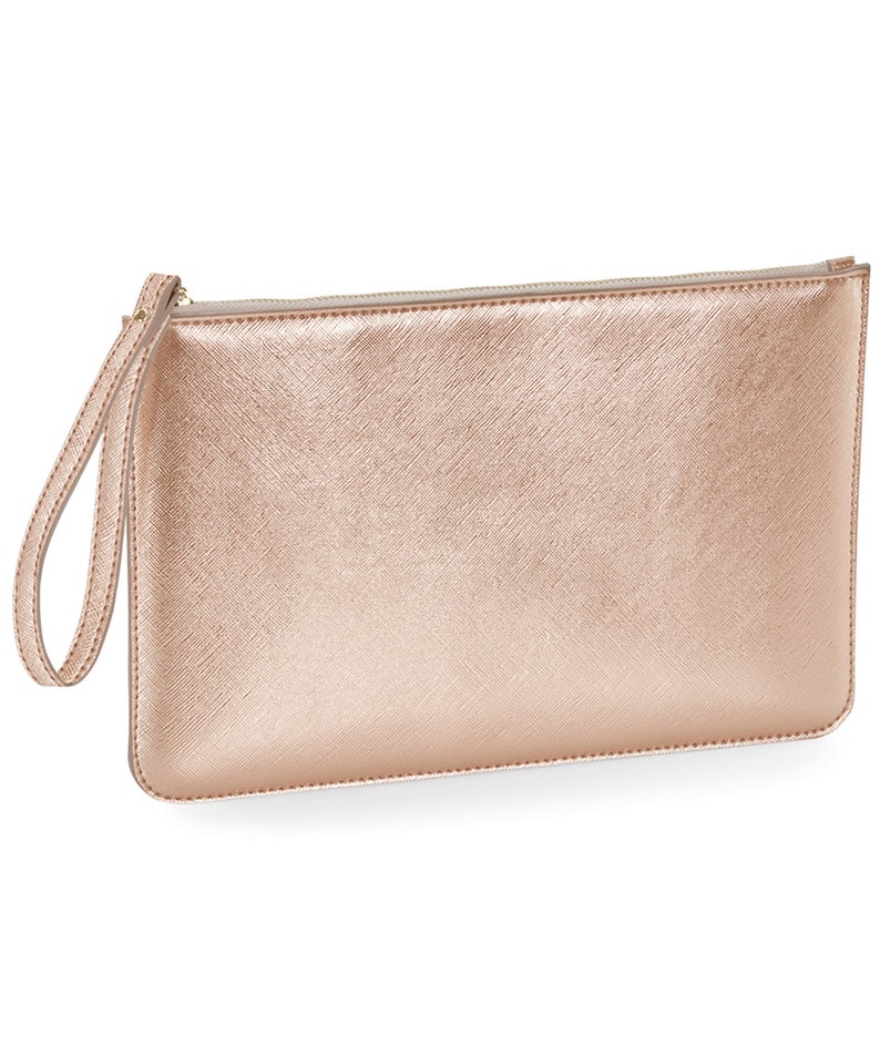 May include: A rose gold clutch purse with a zipper closure and a wrist strap.