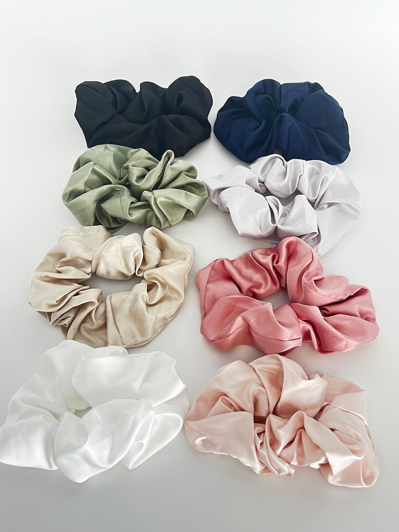 May include: Set of ten satin scrunchies in various colors, including black, green, white, pink, and beige.