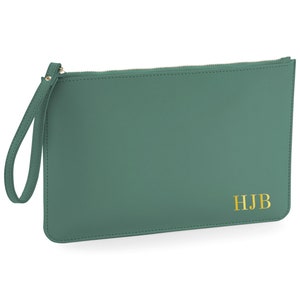 May include: A green leather clutch with a zipper closure and a wrist strap. The clutch has the initials "HJB" embossed in gold on the front.