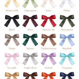 May include: A ribbon color guide featuring twenty satin bows arranged in a grid. Each bow is labeled with its color name, including buttermilk, sage green, ivory, white, black, wine, scarlet red, moss green, taupe, spruce, turftan brown, bluebell, ice pink, light silver, ochrid, turquoise, tan, brown, torrid orange, and navy.