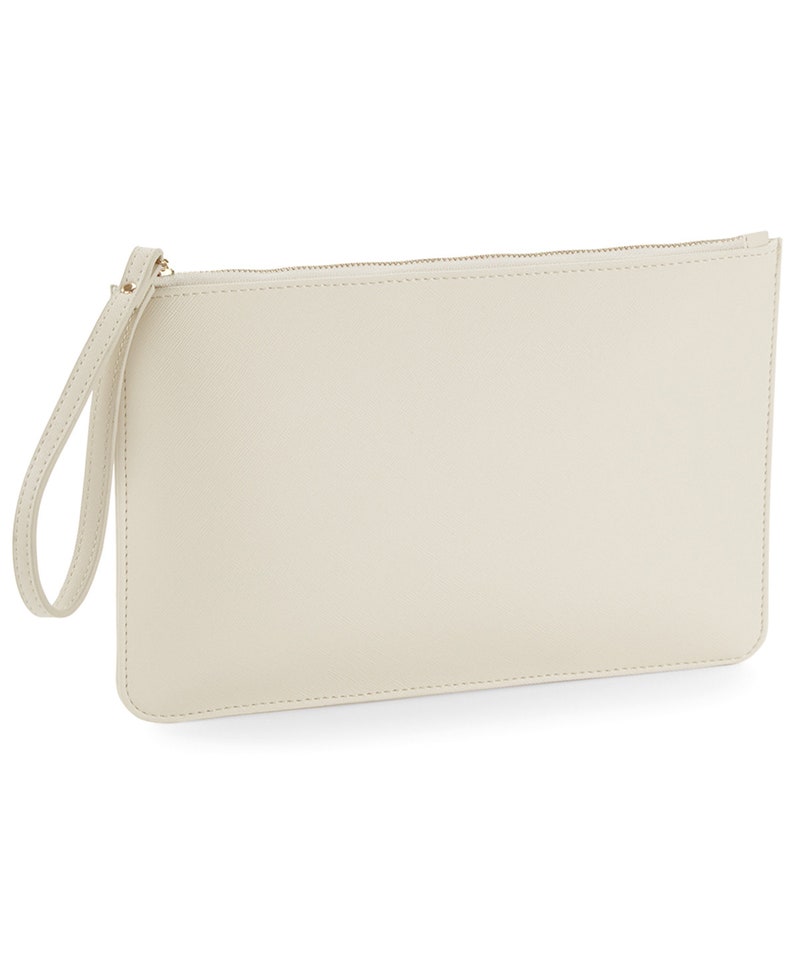 May include: A cream-colored clutch purse with a zipper closure and a wrist strap.
