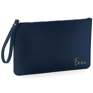 May include: A navy blue zippered clutch with a gold zipper and a gold inscription that reads "Emma".