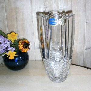 May include: A clear glass vase with a textured design and a blue label that reads "Bohemian Crystal Czech Republic".