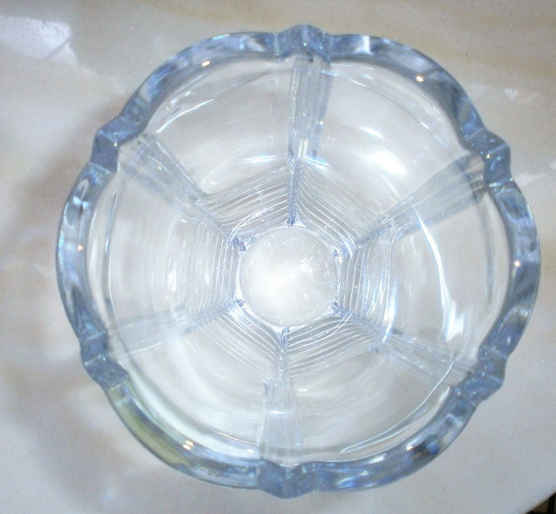 May include: A clear glass vase with a fluted design and a hexagonal base.