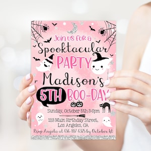 May include: A pink Halloween party invitation with the text "Join us for a Spooktacular PARTY Madison's 5th BOO-DAY". The invitation includes illustrations of ghosts, bats, spiders, and pumpkins. The invitation is held by a person.