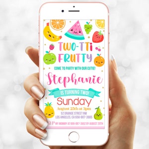 May include: A colorful digital invitation for a two-year-old's birthday party. The invitation features a cartoon watermelon, pineapple, pear, and other fruits with smiling faces. The text reads "TWO-TTi FRUTTY COME TO PARTY WITH OUR CUTIE! Stephanie IS TURNING TWO! Sunday August 25th at 3pm 52 ORANGE STREET NW LOS ANGELES, CA 656-887-3685 SUP MY MOMMY AT 696-887-3662 BY AUGUST 20TH"