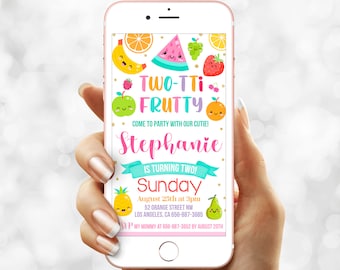 May include: A digital invitation on a smartphone with a colorful fruit theme. The text reads "TWO-TTI FRUTTY" and announces a birthday party for Stephanie. Includes date, time, and location details.