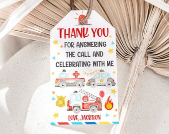 May include: Thank you for answering the call and celebrating with me.  A white tag with red, blue, and yellow accents features a fire truck, ambulance, and police car.  The text "Love, Jackson" is at the bottom of the tag.