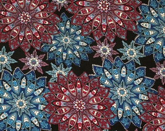 May include: A black fabric with a repeating pattern of blue, red, and white mandala designs. The mandalas are intricate and detailed, with a variety of shapes and patterns.