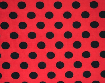 May include: Red fabric with a black polka dot pattern.