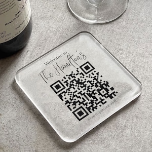 May include: A clear glass coaster with a black and white QR code and the text "Welcome to The Hamilton's" and "Scan to join our wi-fi".