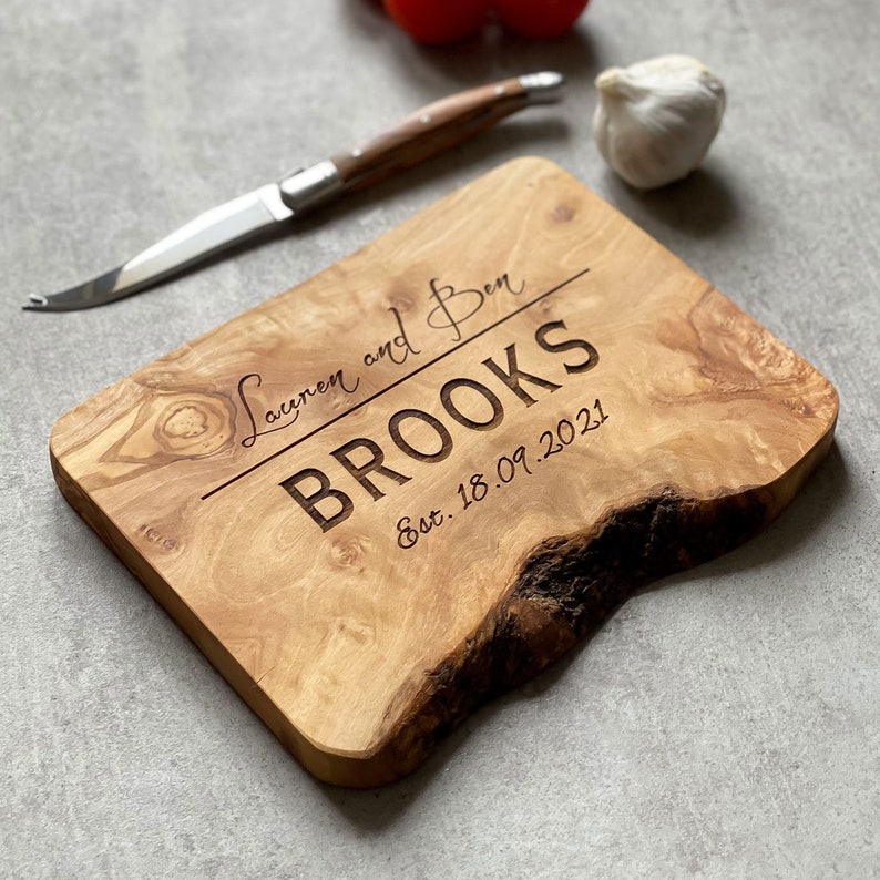 A beautifully designed, unique and custom engraved personalized gift. Crafted from rustic olive wood and ideal to use as chopping, serving, charcuterie or antipasti board, made from sustainable, natural olive wood.