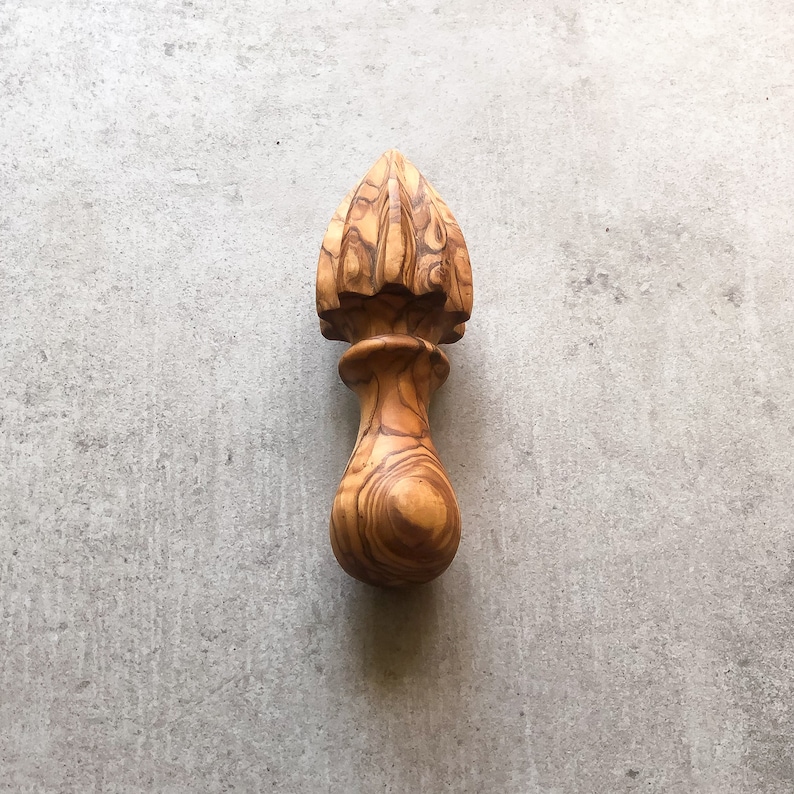 Traditional olive wood lemon squeezer.