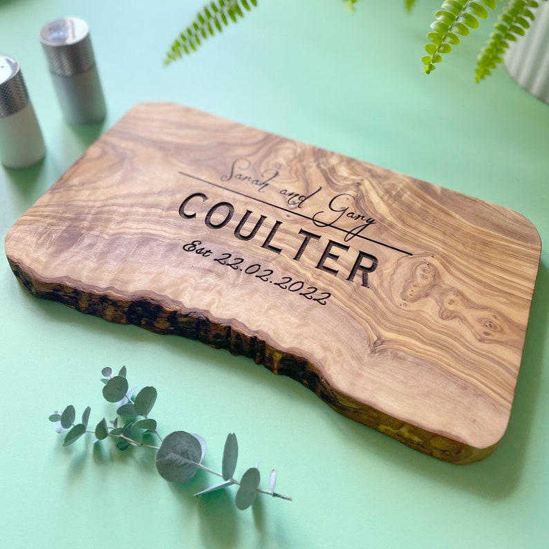 A beautifully designed, unique and custom engraved personalized gift. Crafted from rustic olive wood and ideal to use as chopping, serving, charcuterie or antipasti board, made from sustainable, natural olive wood.