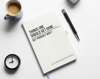 May include: A white notebook with the text "THINGS ONE SHOULD GET DONE... BUT PROBABLY WON'T" and the author's name. A black pen, a small clock, a cup of coffee, and a small potted plant are also visible.