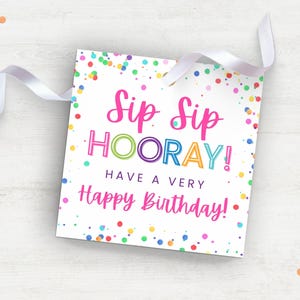 May include: A white card with colorful confetti printed on it. The card says "Sip Sip Hooray! Have a Very Happy Birthday!"