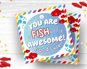 May include: A blue and white card with a rainbow border and the text "You are Fish-ally Awesome! Good Luck!" in red and black lettering. The card has a cartoon fish and bubbles on it.