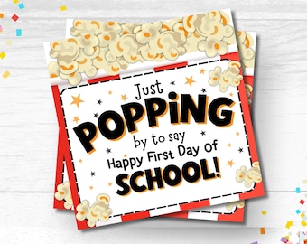 May include: A printable card with a red and white striped background and a picture of popcorn. The card says "Just Popping by to say Happy First Day of School!"
