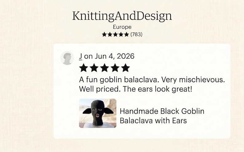 May include: A black knitted balaclava featuring prominent pointed ears and a cutout for the eyes and mouth. The item is displayed on a mannequin head, showcasing the textured fabric construction and the distinct goblin-like ear design.
