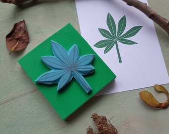 An handcarved chestnut tree leaf stamp on a woodblock