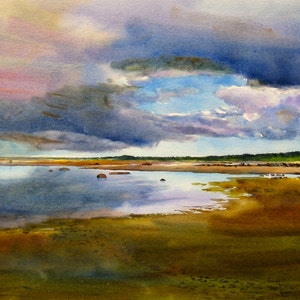 May include: A watercolor painting of a seascape with a dramatic sky. The sky is a mix of dark blue, purple, and pink clouds, with a sliver of blue sky peeking through. The water is a calm blue, reflecting the sky above. The foreground is a sandy beach with green grass.