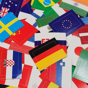 May include: A collection of small, colorful flags representing different countries. The flags are arranged in a random pattern and include flags from the United States, Germany, Sweden, China, and many more.