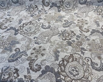 May include: A fabric with a repeating pattern of stylized flowers and leopards in shades of gray, brown, and beige. The design has a vintage, ornate feel, suitable for upholstery or decorative projects.