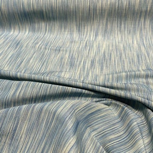 May include: A blue and white striped fabric with a subtle sheen. The fabric is woven with a fine texture and has a soft, drapey feel.