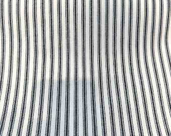 May include: White fabric with thin black stripes. The fabric has a subtle texture.