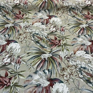 May include: A beige fabric with a repeating pattern of large, white flowers and green leaves. The flowers have a watercolor effect and are accented with shades of pink and brown.