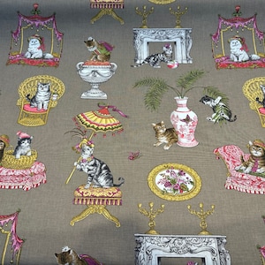 May include: A brown fabric with a repeating pattern of cats in various poses. The cats are wearing hats and sitting on furniture, such as chairs, couches, and beds. The background is a light brown colour.