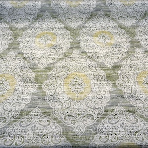 May include: A green and white patterned fabric with a damask design. The fabric has a subtle sheen and a textured surface.