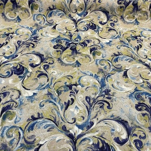 May include: A fabric with a blue, green, and white damask pattern. The fabric has a textured surface and a subtle sheen.