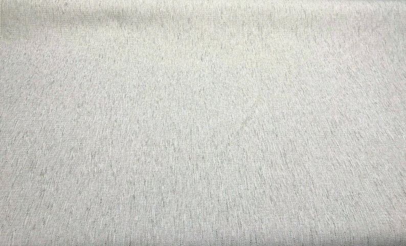 May include: A close-up of a white textured fabric with a subtle sheen. The fabric has a fine weave and a smooth, even surface.