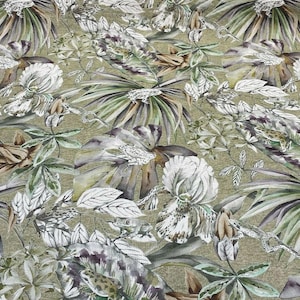 May include: A green and white floral fabric with a tropical print. The fabric features large white flowers, green leaves, and brown stems.