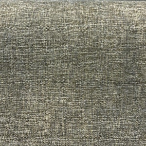 May include: Close-up of a textured fabric with a subtle sheen. The fabric has a woven pattern with a mix of light and dark brown threads.