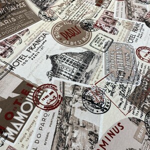 May include: A beige fabric with a repeating pattern of vintage travel stamps and postcards. The stamps and postcards feature images of buildings, trains, and other travel-related imagery. The text on the stamps and postcards includes the words "Hotel Francia", "Hotel Do Paro", "Royal Paris", "Chatham Paris", and "Terminus".