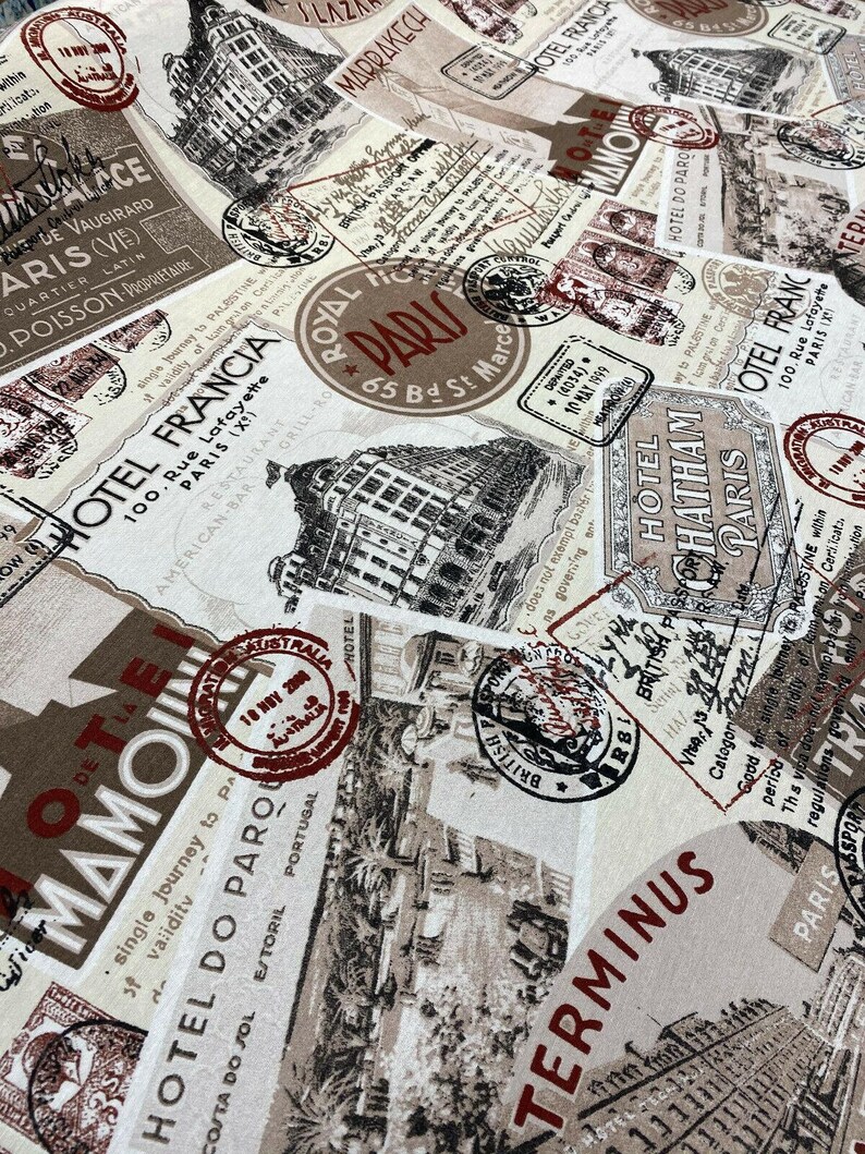 May include: A beige fabric with a repeating pattern of vintage travel stamps and postcards. The stamps and postcards feature images of buildings, trains, and other travel-related imagery. The text on the stamps and postcards includes the words "Hotel Francia", "Hotel Do Paro", "Royal Paris", "Chatham Paris", and "Terminus".